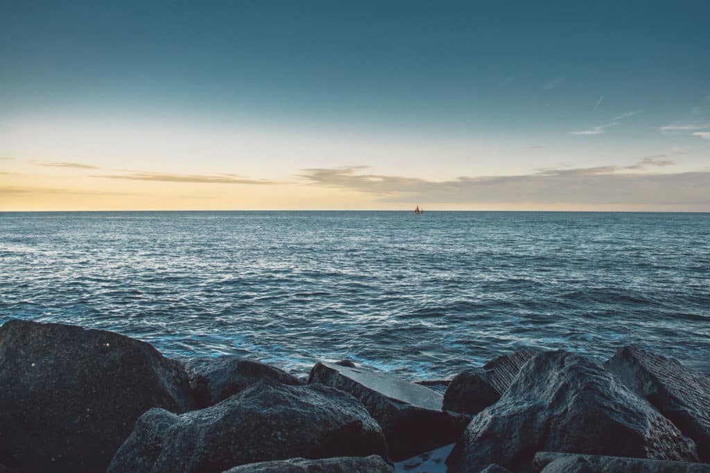 rock formation beside ocean during daytime