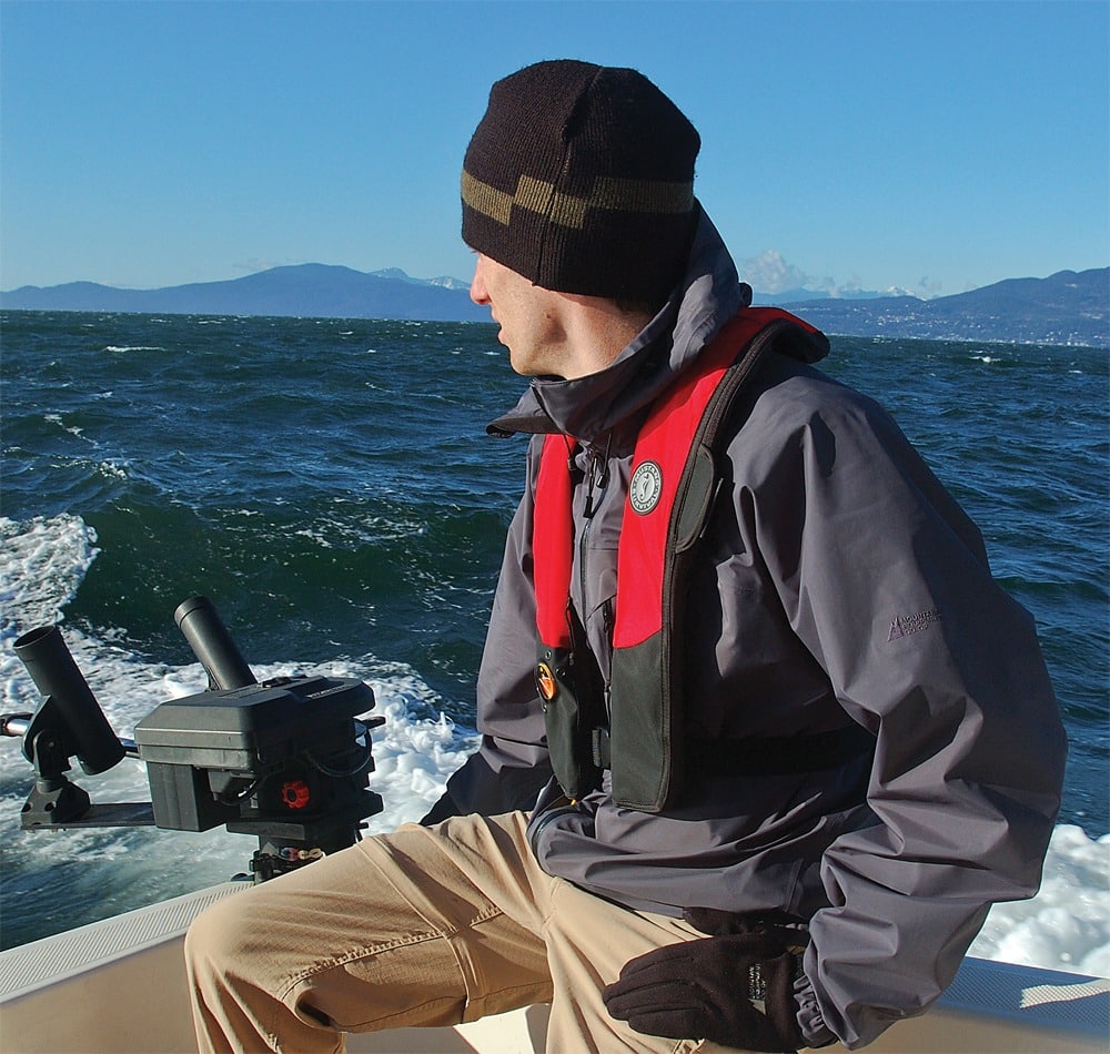 man navigating small boat.