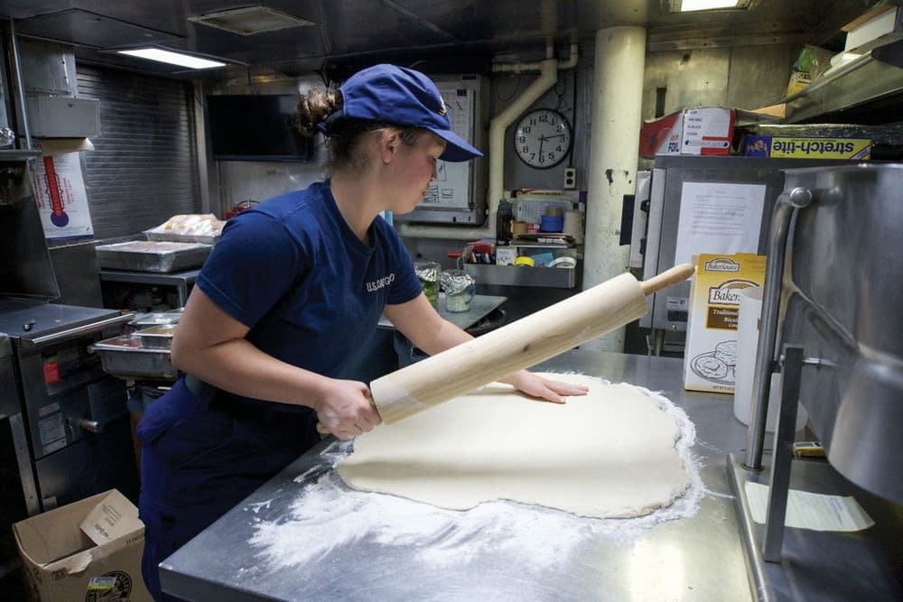 Culinarian rolling out dough