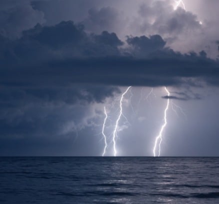 A thunder and lightning storm at sea.