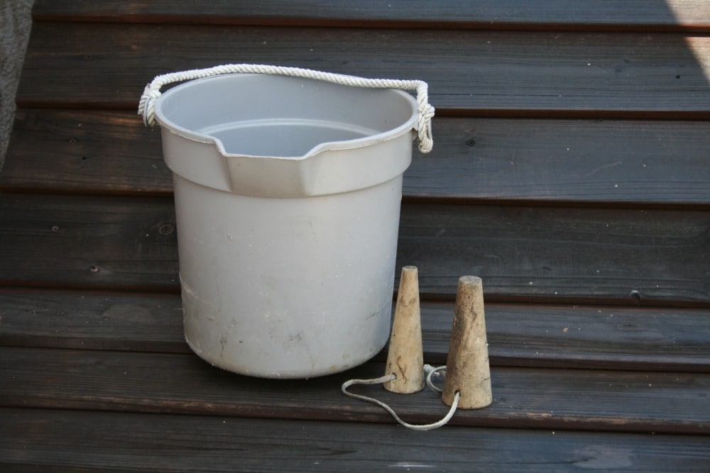 A bucket on a wooden pier.