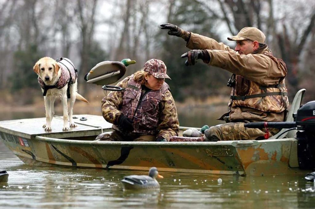 Duck hunters throwing out decoys
