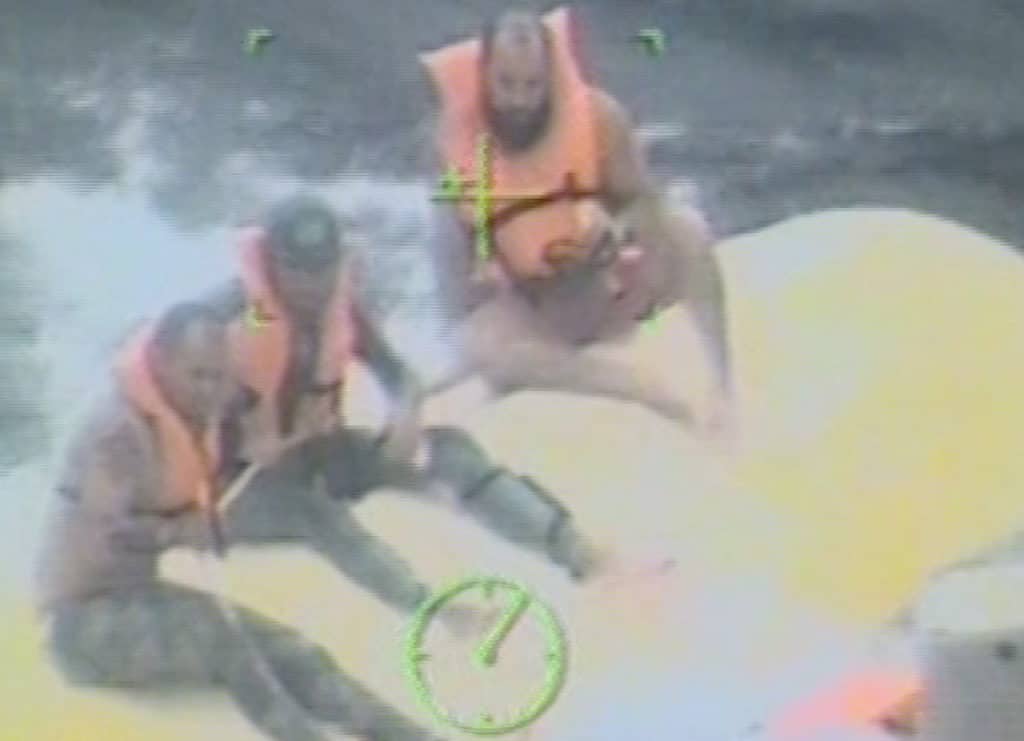 Coast Guard video of fishermen on overturned boat