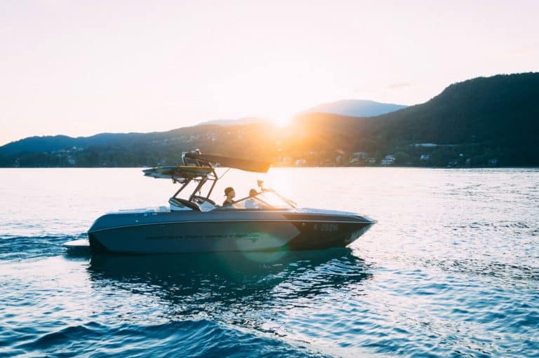 A boat on the water at sunset.