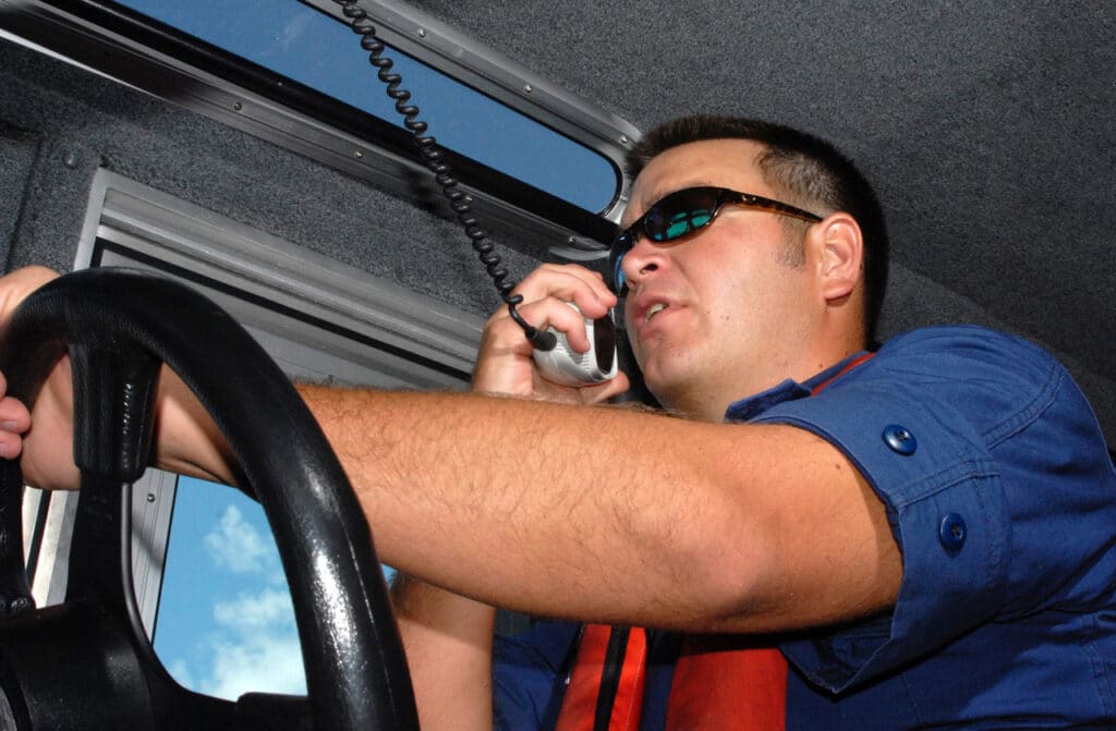 Speaking into a VHF radio.